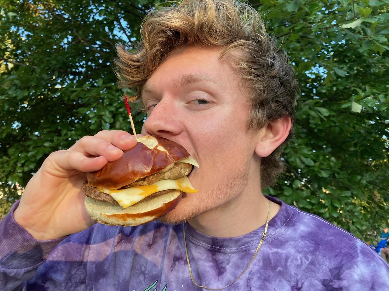 Guy eating brat burger